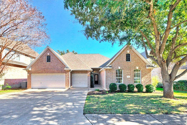 front of property featuring central air condition unit, a front yard, and a garage