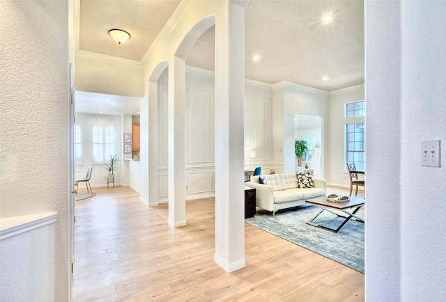 interior space featuring ornamental molding and light hardwood / wood-style floors