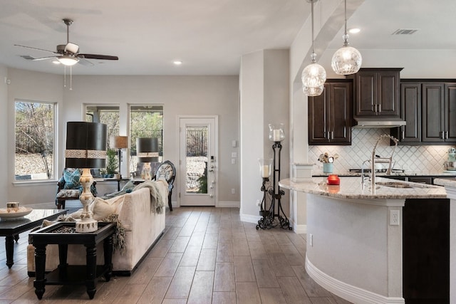 17820 Limestone Spring Ln, Austin, TX 78738 - living area with a ceiling fan, healthy amount of natural light, wood finished floors, and recessed lighting