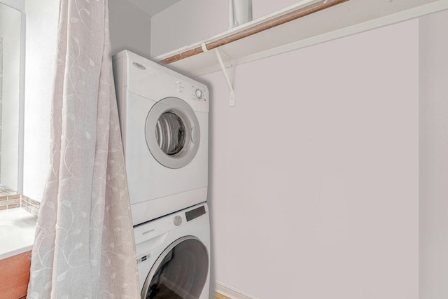 laundry area featuring stacked washer / dryer