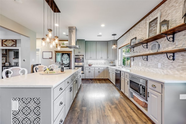 kitchen with island range hood, gray cabinets, stainless steel appliances, a center island, and backsplash