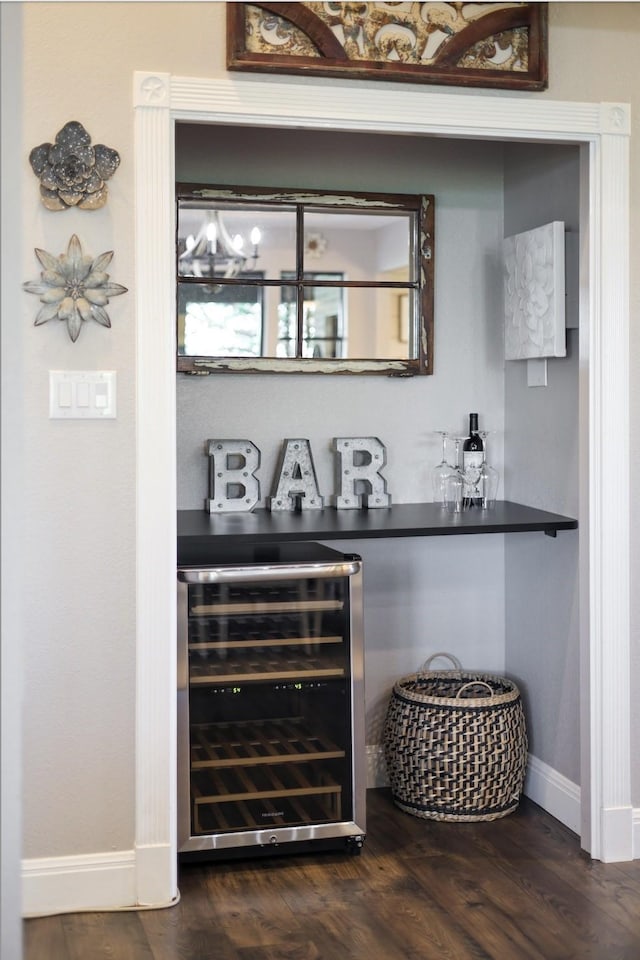 bar with dark hardwood / wood-style flooring and wine cooler