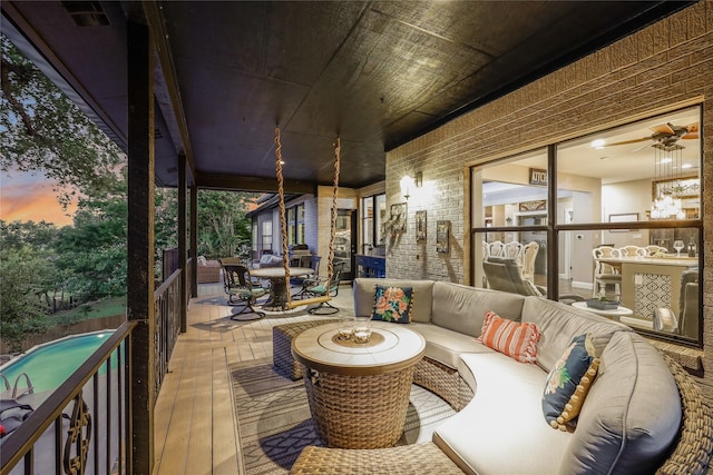 deck at dusk featuring an outdoor living space