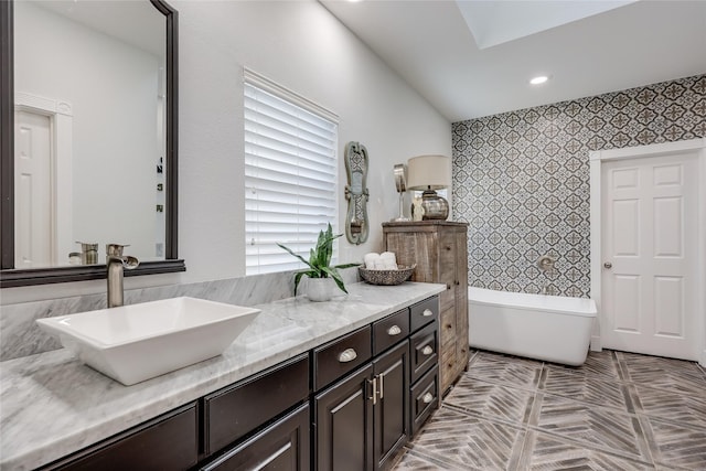 bathroom featuring vanity and a tub