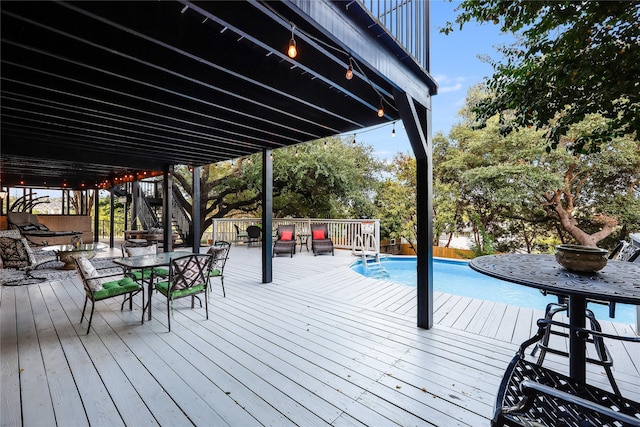 wooden deck with a fenced in pool