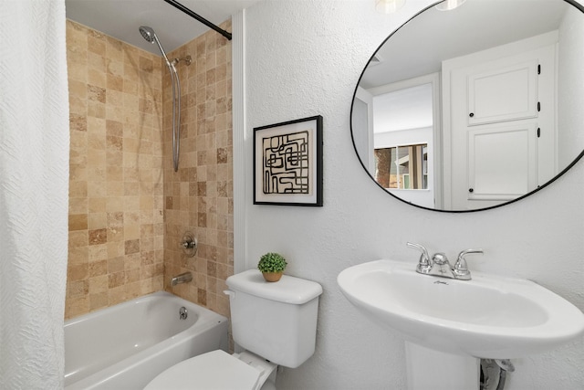 full bathroom with sink, shower / tub combo, and toilet