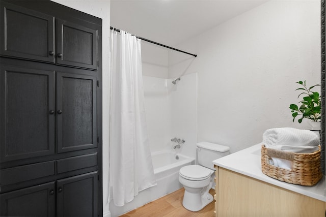 bathroom featuring hardwood / wood-style floors, shower / bath combination with curtain, and toilet