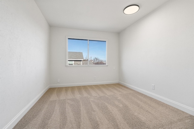 empty room with light colored carpet