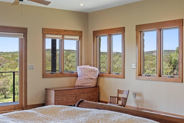 bedroom featuring ceiling fan and multiple windows