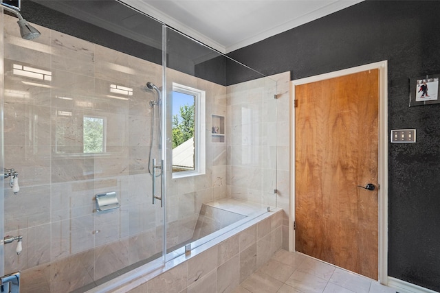 bathroom with ornamental molding, tiled shower, and tile patterned floors