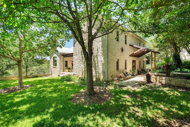 exterior space with a patio and a lawn