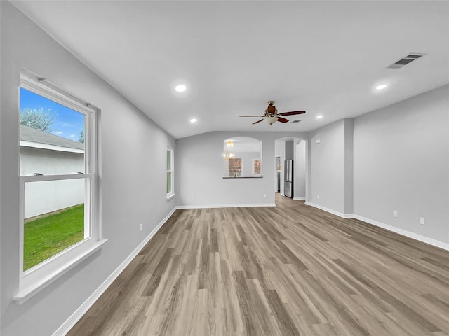 unfurnished living room with ceiling fan, light hardwood / wood-style floors, and plenty of natural light