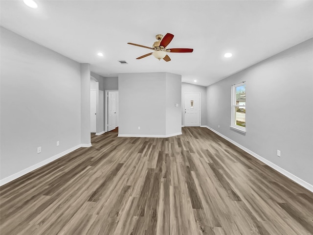 unfurnished living room featuring ceiling fan, hardwood / wood-style floors, and vaulted ceiling