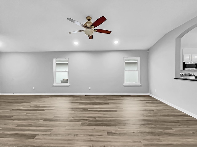 unfurnished room with ceiling fan and hardwood / wood-style flooring