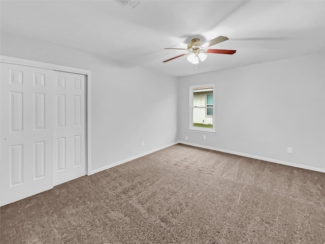 spare room featuring carpet flooring and ceiling fan