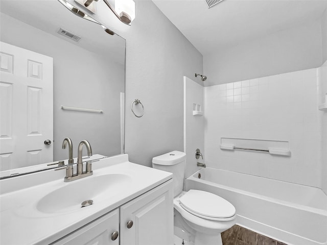 full bathroom with toilet, wood-type flooring, vanity, and washtub / shower combination