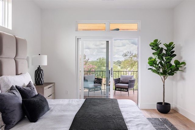 bedroom with light wood-type flooring and access to outside