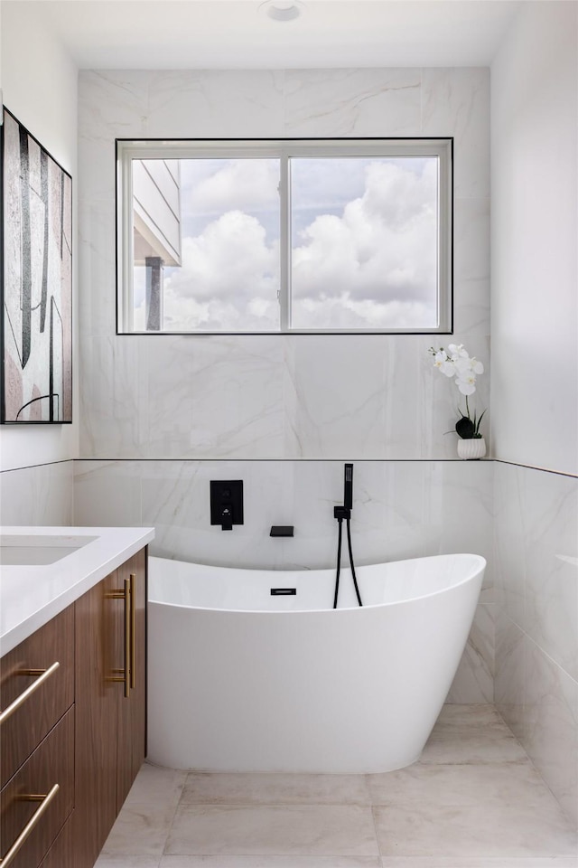 bathroom featuring vanity and a washtub