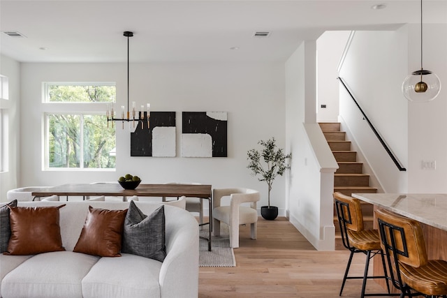 living room featuring a chandelier and light hardwood / wood-style floors