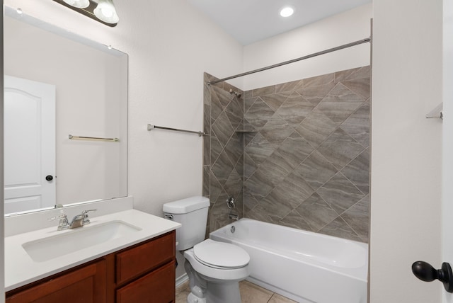 full bathroom featuring toilet, vanity, and tiled shower / bath