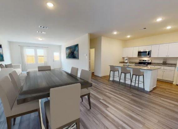 dining space with light hardwood / wood-style floors