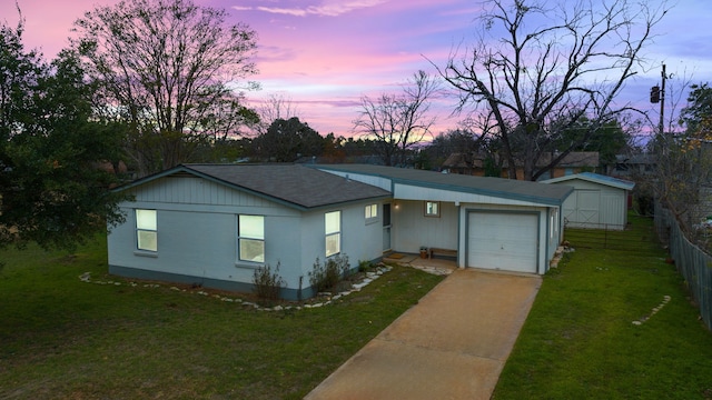 ranch-style home with a yard and a garage