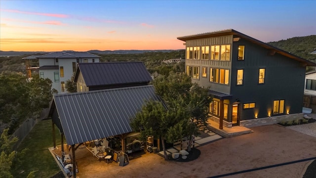 view of back house at dusk