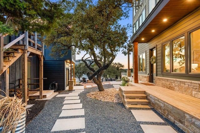 yard at dusk with a wooden deck