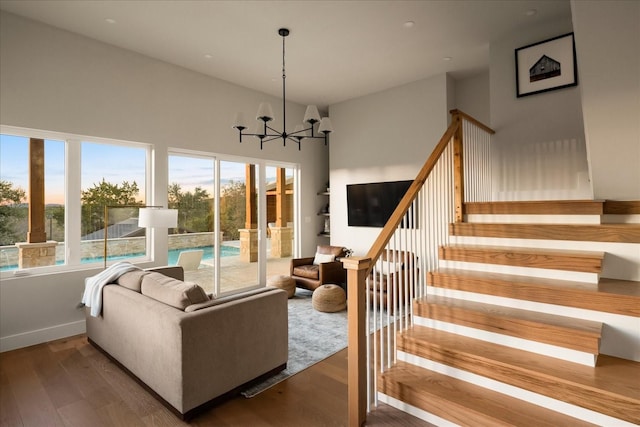 living room featuring hardwood / wood-style flooring and an inviting chandelier