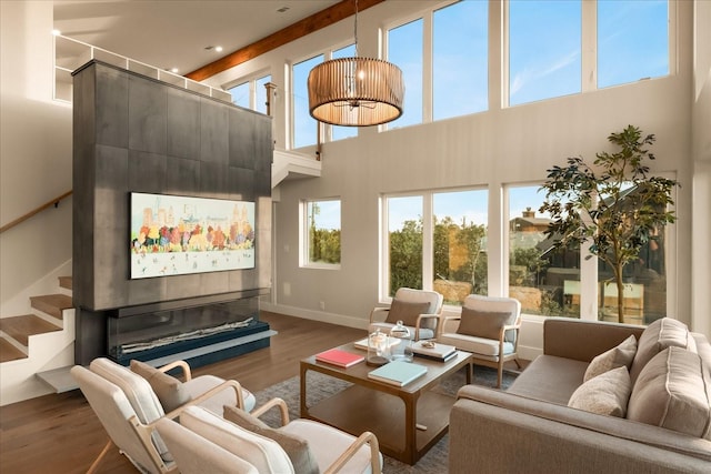 living room featuring a high ceiling and wood-type flooring