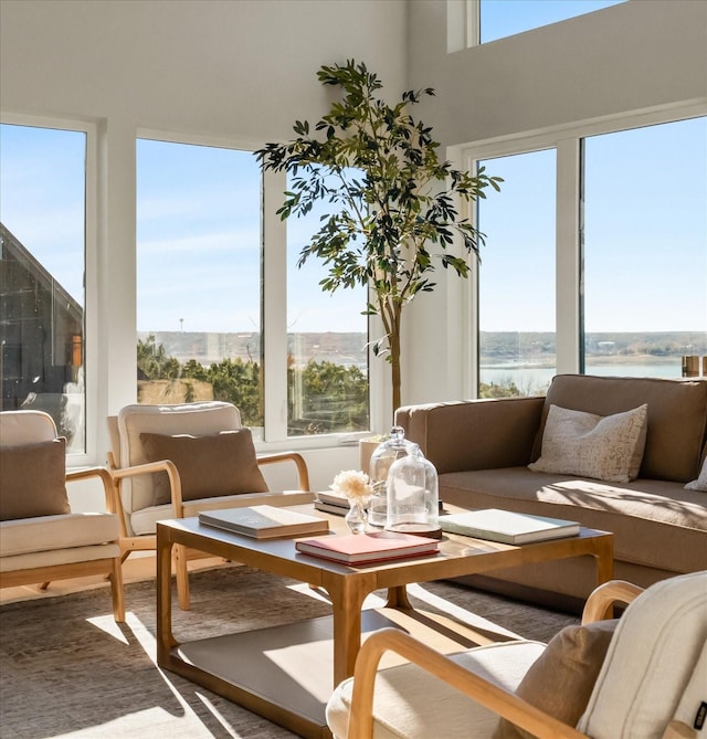 sunroom featuring a water view