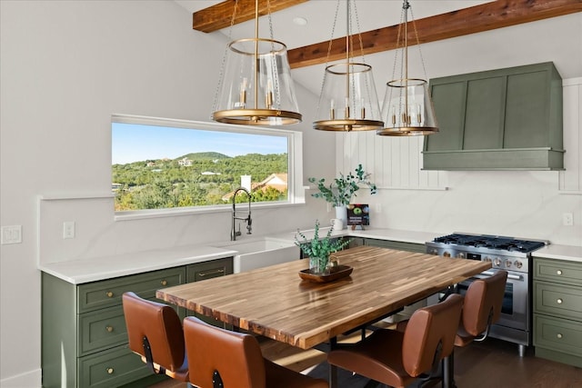 kitchen featuring sink, decorative light fixtures, green cabinetry, stainless steel gas range, and beam ceiling