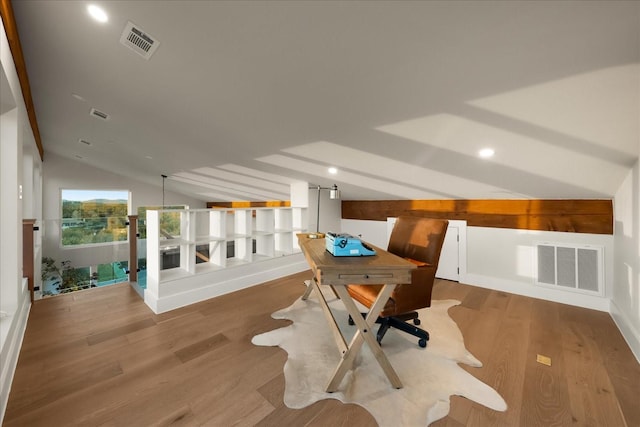 office area with hardwood / wood-style flooring and vaulted ceiling