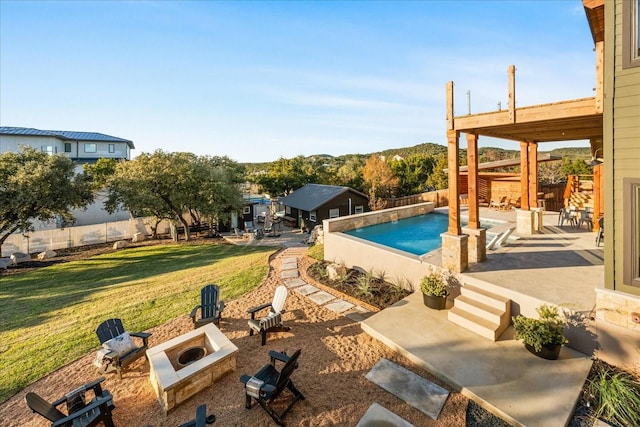 view of pool with a patio area, a lawn, and an outdoor fire pit