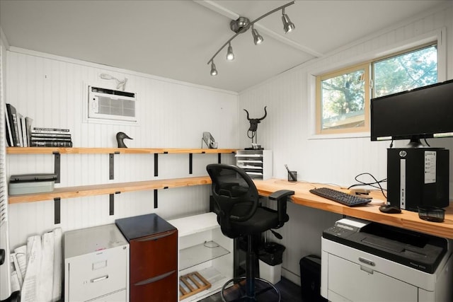 office space with track lighting and an AC wall unit