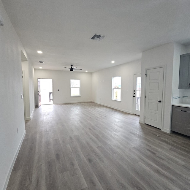 unfurnished living room featuring hardwood / wood-style flooring and ceiling fan