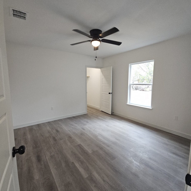 unfurnished room with hardwood / wood-style floors and ceiling fan