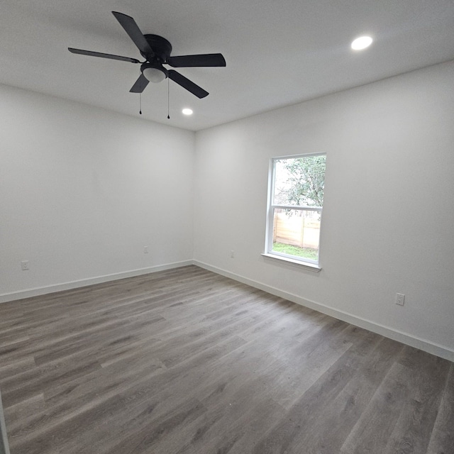 spare room with ceiling fan and dark hardwood / wood-style floors