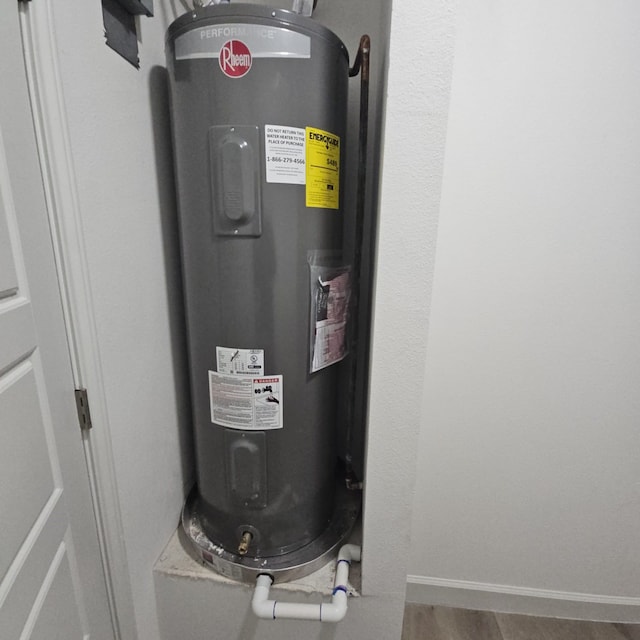 utility room featuring water heater