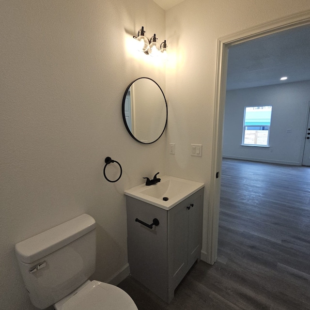 bathroom featuring hardwood / wood-style floors, vanity, and toilet