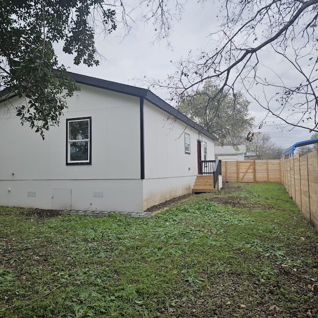 view of property exterior with a lawn