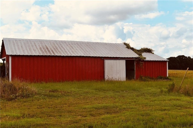 view of outbuilding featuring a lawn