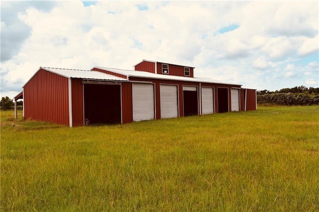 view of outdoor structure with a yard and a garage