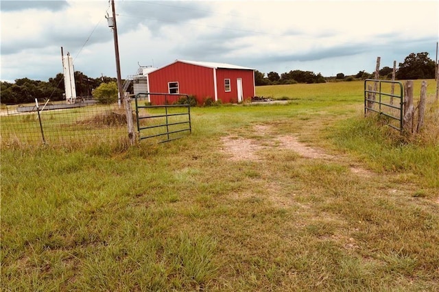 view of yard featuring an outbuilding and a rural view