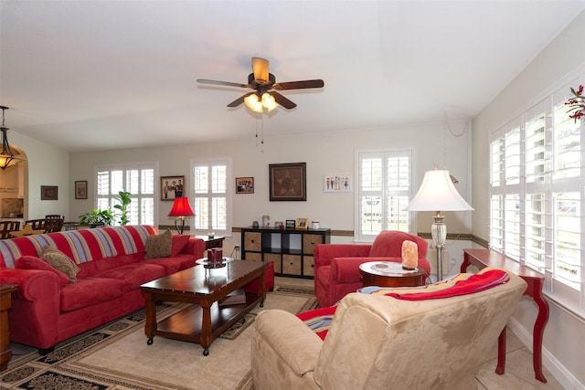 tiled living room with ceiling fan and plenty of natural light