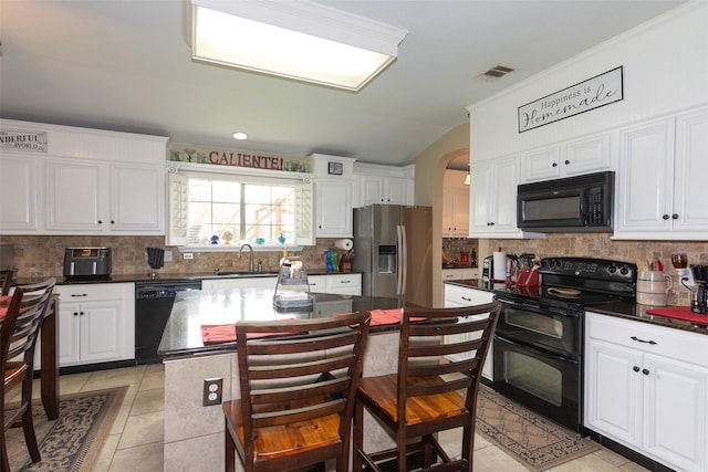 kitchen featuring black appliances, white cabinetry, a center island, and sink