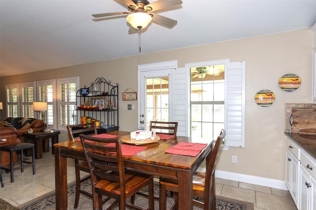 dining area featuring ceiling fan, a healthy amount of sunlight, and light tile patterned floors