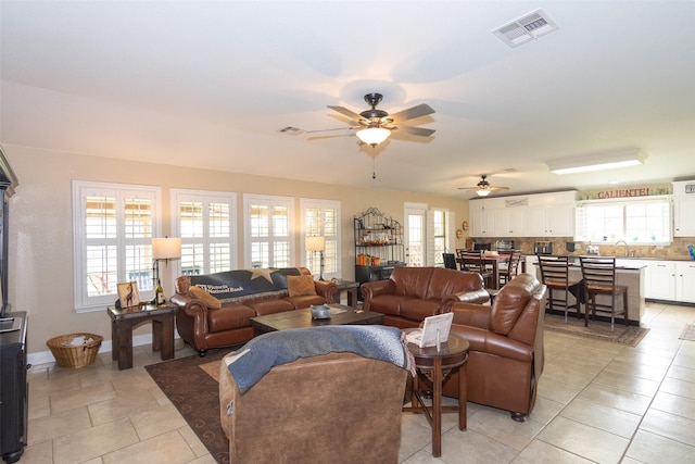 living room with light tile patterned flooring and ceiling fan