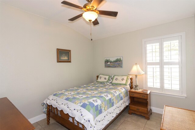 bedroom featuring ceiling fan, vaulted ceiling, and light tile patterned flooring