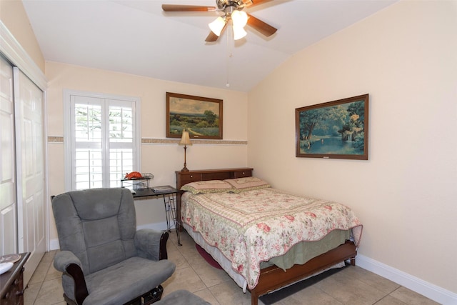 bedroom with ceiling fan, a closet, light tile patterned flooring, and lofted ceiling